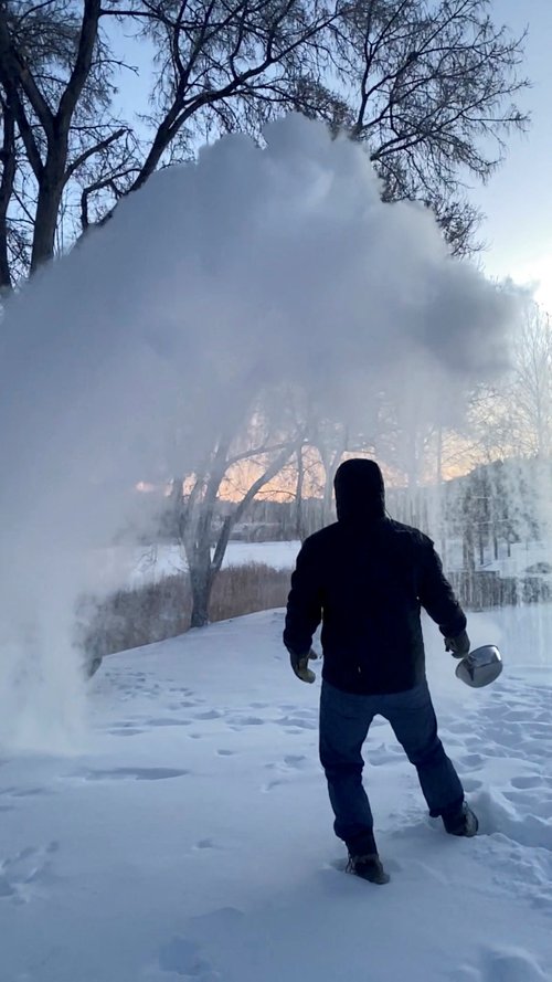 A man tosses hot boiling water in the snow in Carbon County, Montana