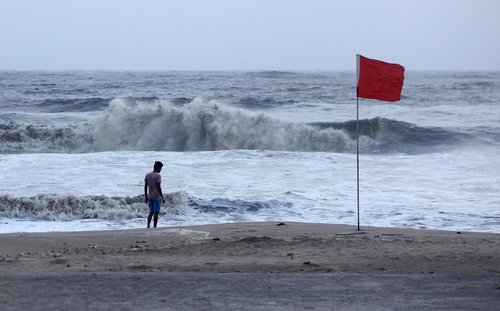 A lifeguard patrols Juhu beach during a red flag alert due to rough seas caused by cyclone Biparjoy, in Mumbai