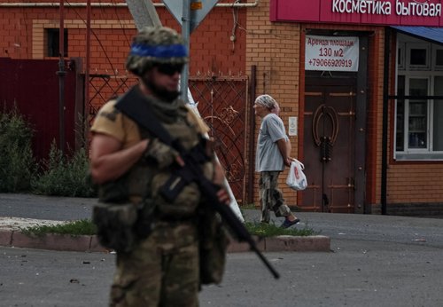 FILE PHOTO: A Ukrainian serviceman patrols in the town of Sudzha