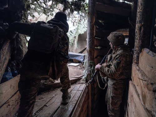 Ukrainian servicemen look out for Russian combat drones at an anti-drone firing position in the frontline city of Kostyantynivka