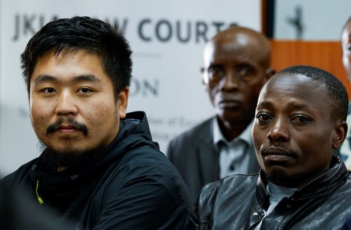 Chinese national Zhang Kequn and Kenyan national Charles Mwangi follow proceedings inside the courtroom on the day Zhang pleaded guilty to charges of dealing with wildlife species without a permit and illegal possession of garden ants