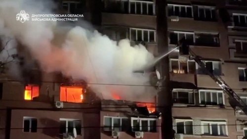 A firefighter works to control a fire in an apartment block that was damaged in a Russian strike, amid Russia's attack on Ukraine.