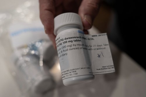 Menta "Steve" Wallace shows a bottle of daraxonrasib, Revolution Medicine?s pancreatic cancer drug, at his home in The Woodlands, Texas, U.S., May 29, 2026. REUTERS/Danielle Villasana