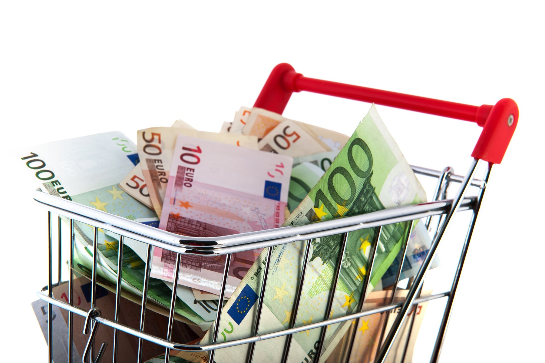 Expensive shopping cart with euro banknotes in different values isolated over white background
