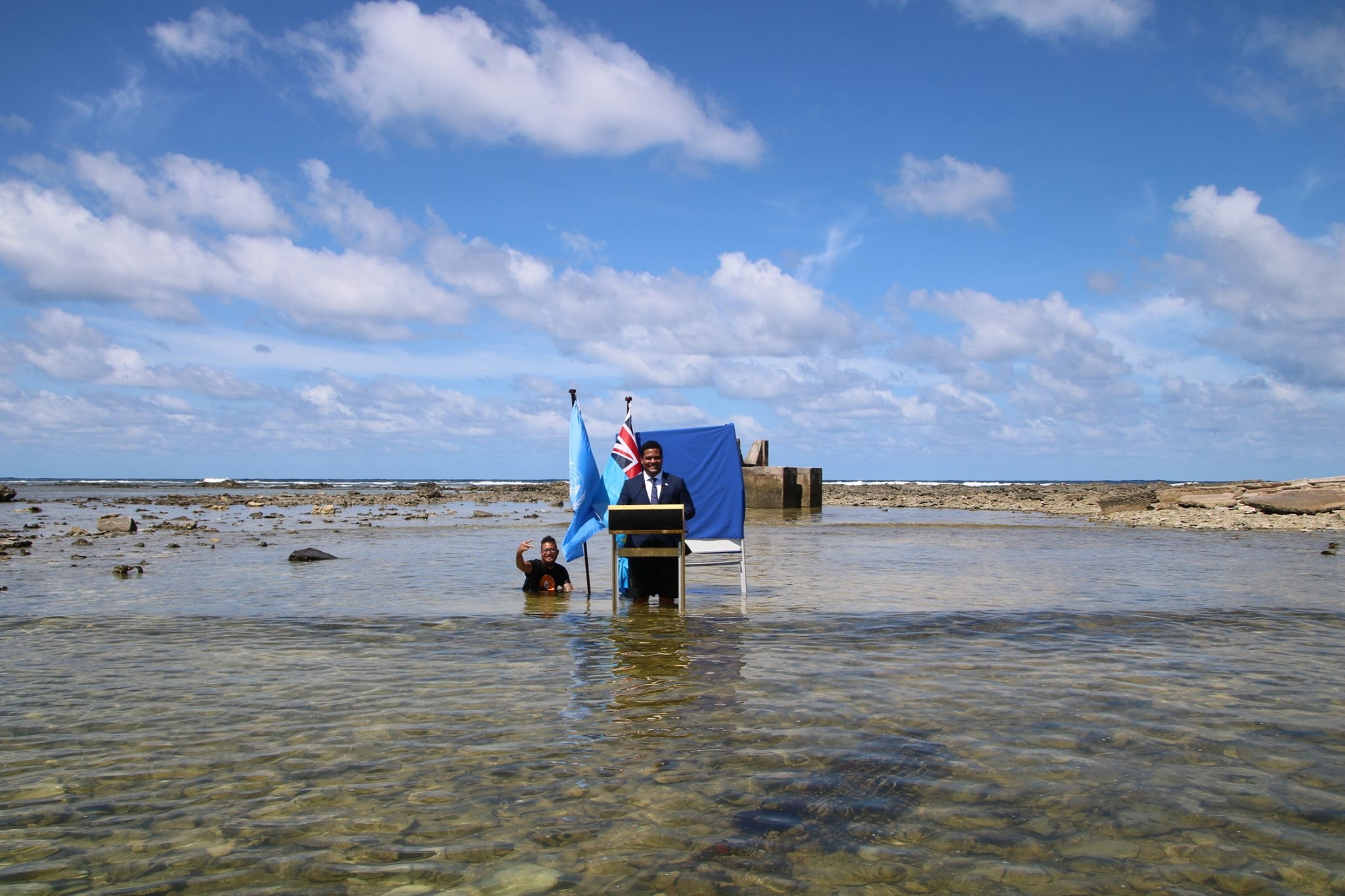 Tuvalu's Minister for Justice, Communication &amp; Foreign Affairs Simon Kofe gives a COP26 statement while standing in the ocean in Funafuti