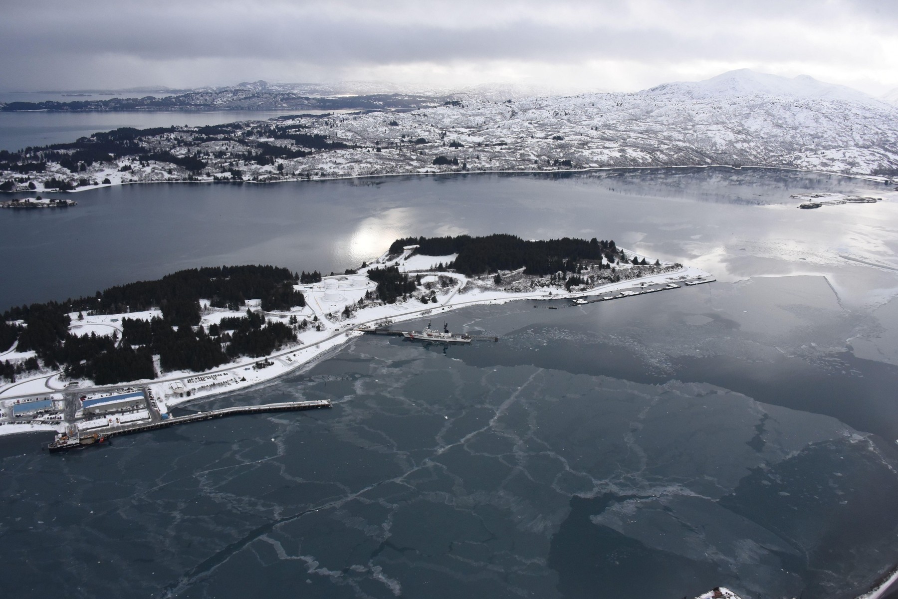 The Coast Guard Cutter SPAR (WLB 206), a 225-foot Juniper class, seagoing buoy tender, and the Coast Guard Cutter Mellon (WHEC 717), a 378-foot Secretary class high endurance cutter, sit moored at adjoining piers in Womens Bay, Base Kodiak, Alaska, Feb. 6