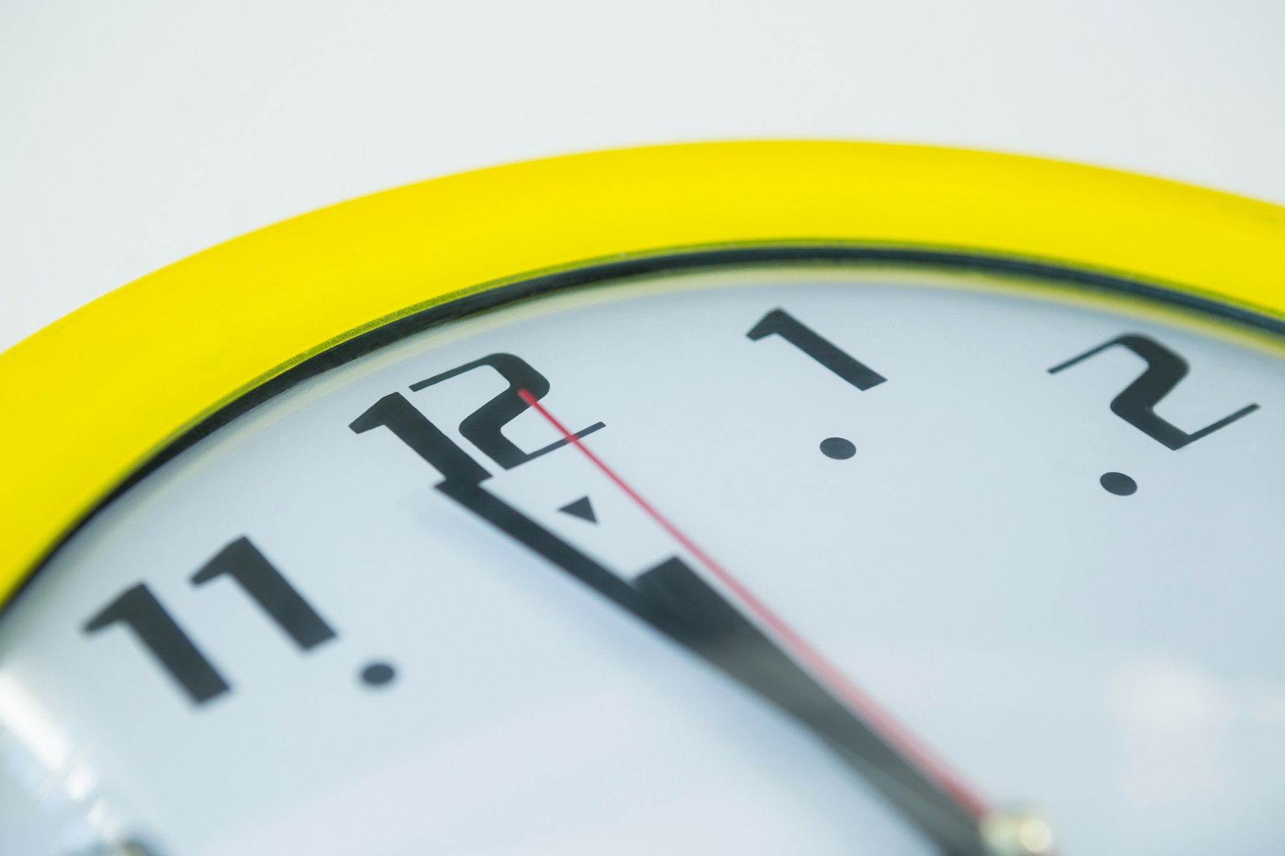 Clock hands reaching 12 o clock midnight