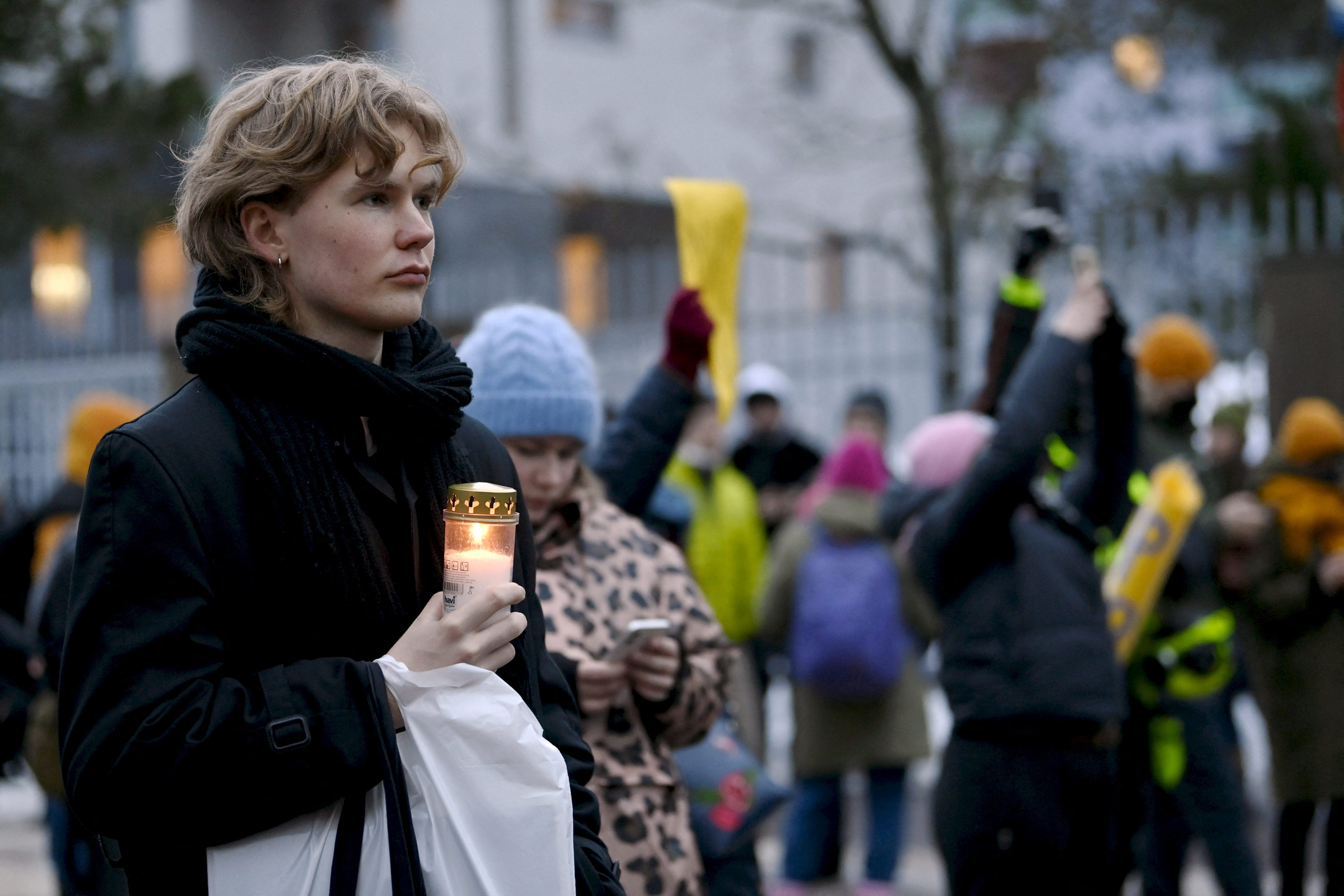 People hold a demonstration against Russia's invasion of Ukraine in front of the Russian embassy in Helsinki