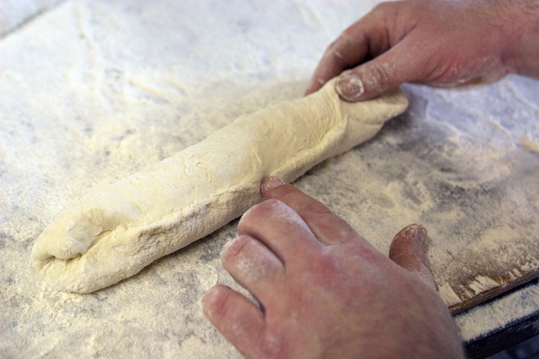 Baker Jacques Langlois shaping a baguette at his bakery on rue Beauvoisine in Rouen, Seine-Maritime, France.