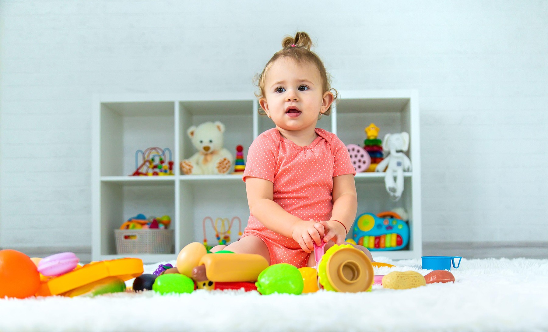 Baby plays with toys in her room. Selective focus. Child.