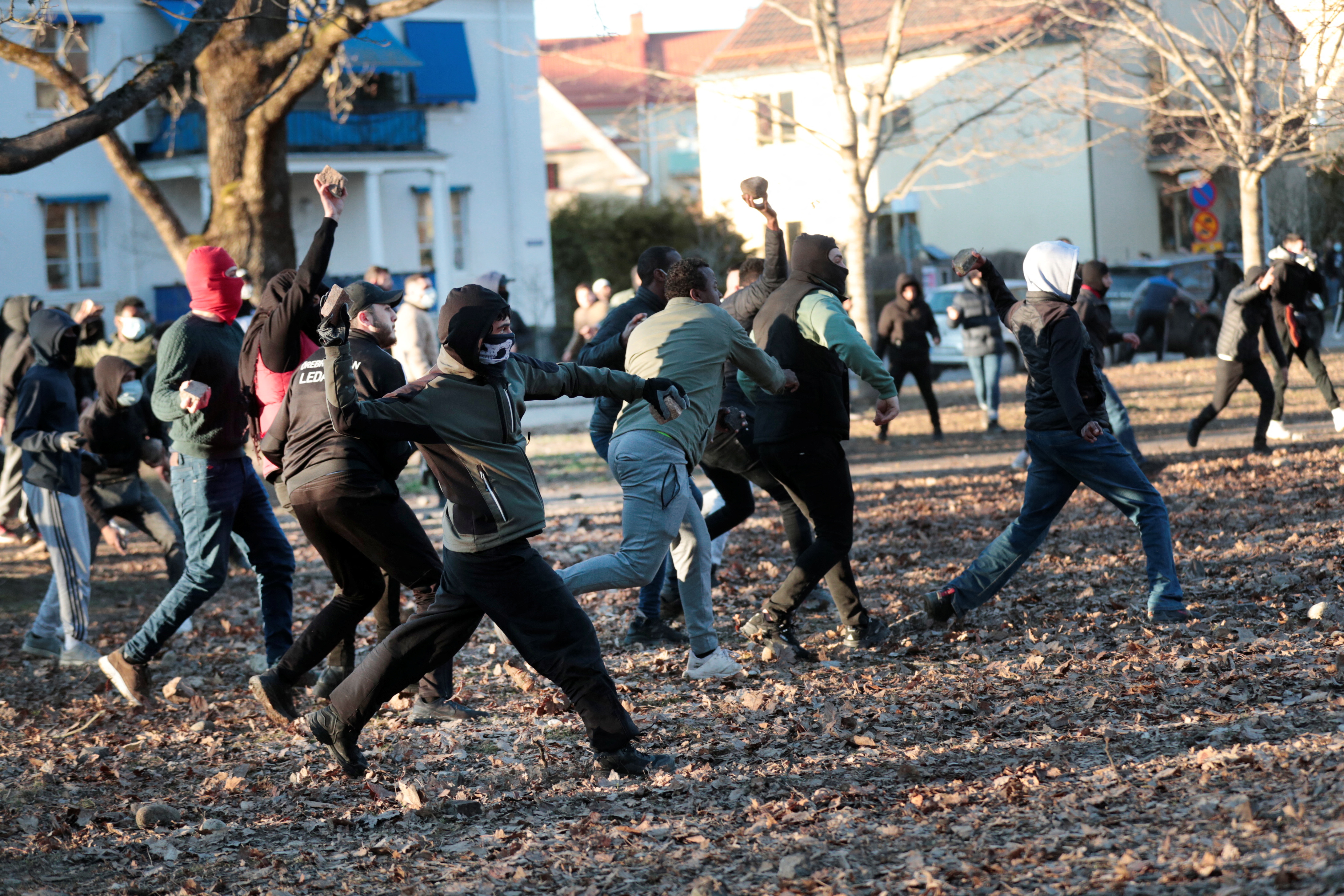 Counter-protesters throw stones at the police ahead of a demonstration planned by Danish anti-Muslim politician Rasmus Paludan
