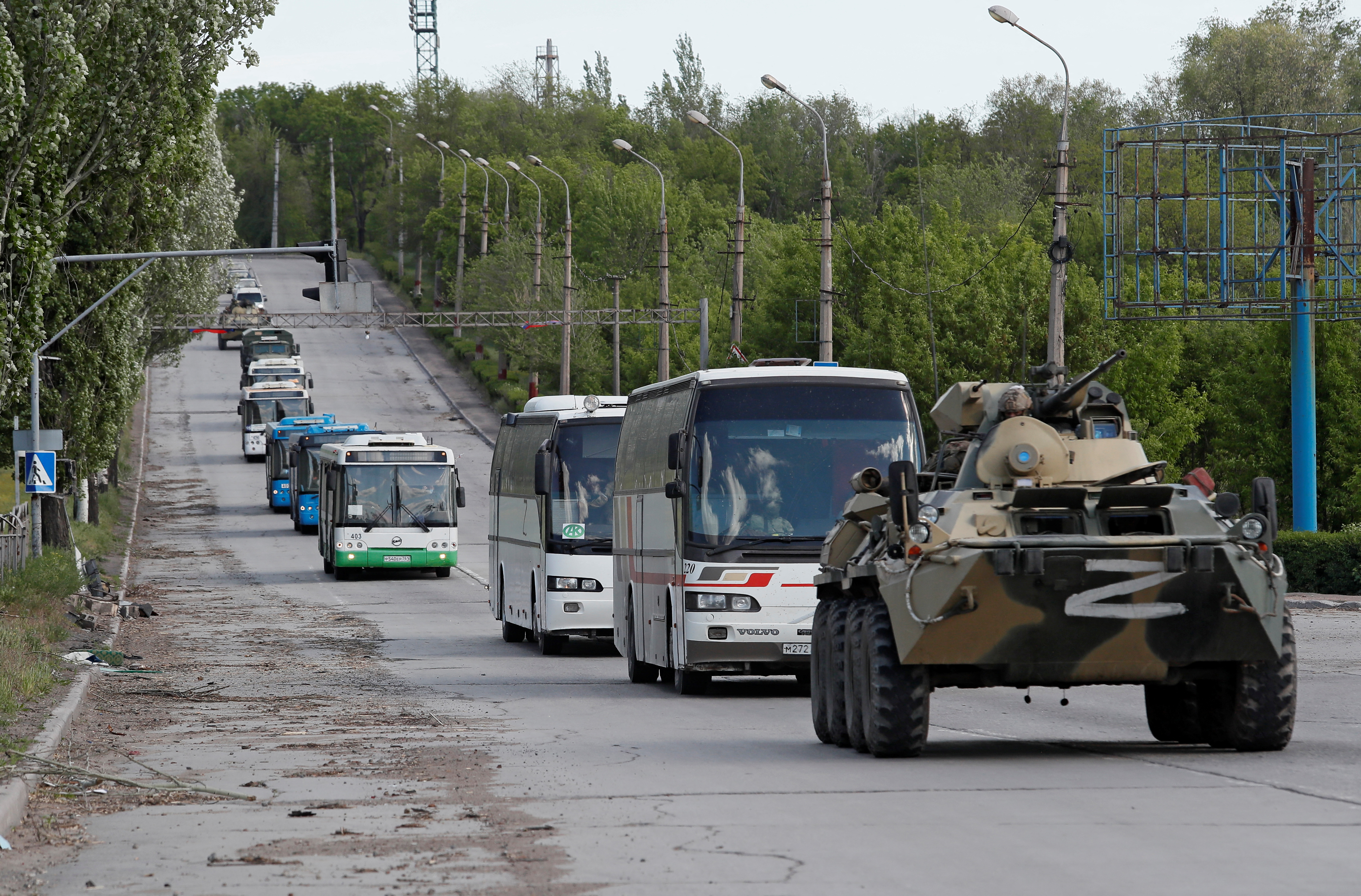 Buses carrying service members of Ukrainian forces who have surrendered after weeks holed up at Azovstal steel works leave Mariupol