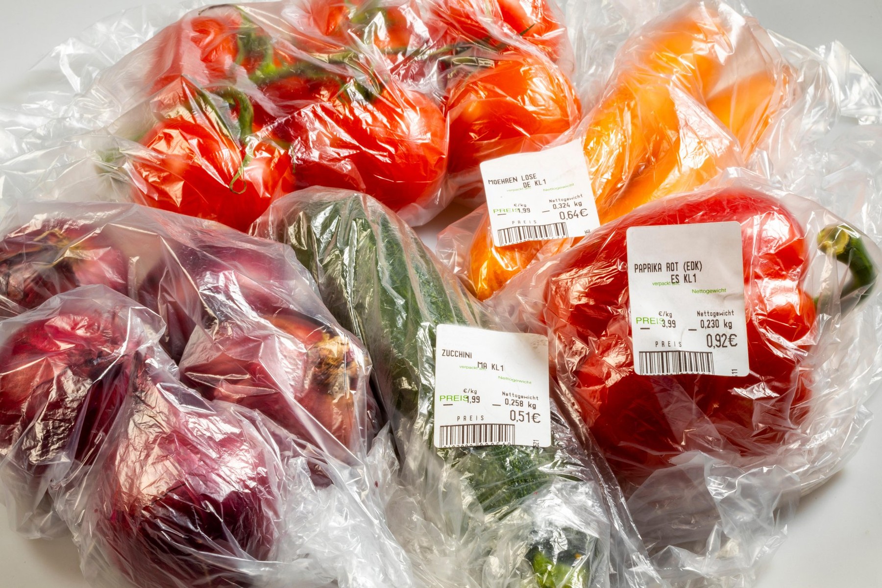 Food packaging, disposable plastic bags, vegetables, peppers, tomatoes, carrots, onions, from the supermarket,