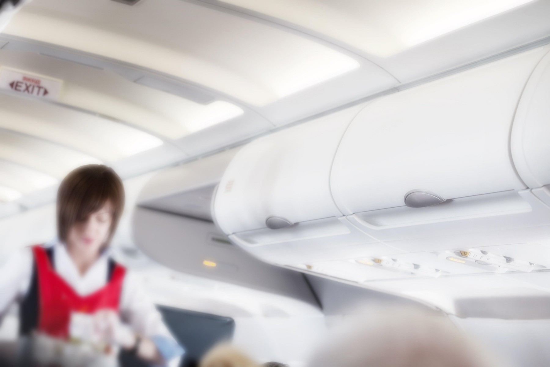 Aairplane cabin with flight attendant shot with blurred focus