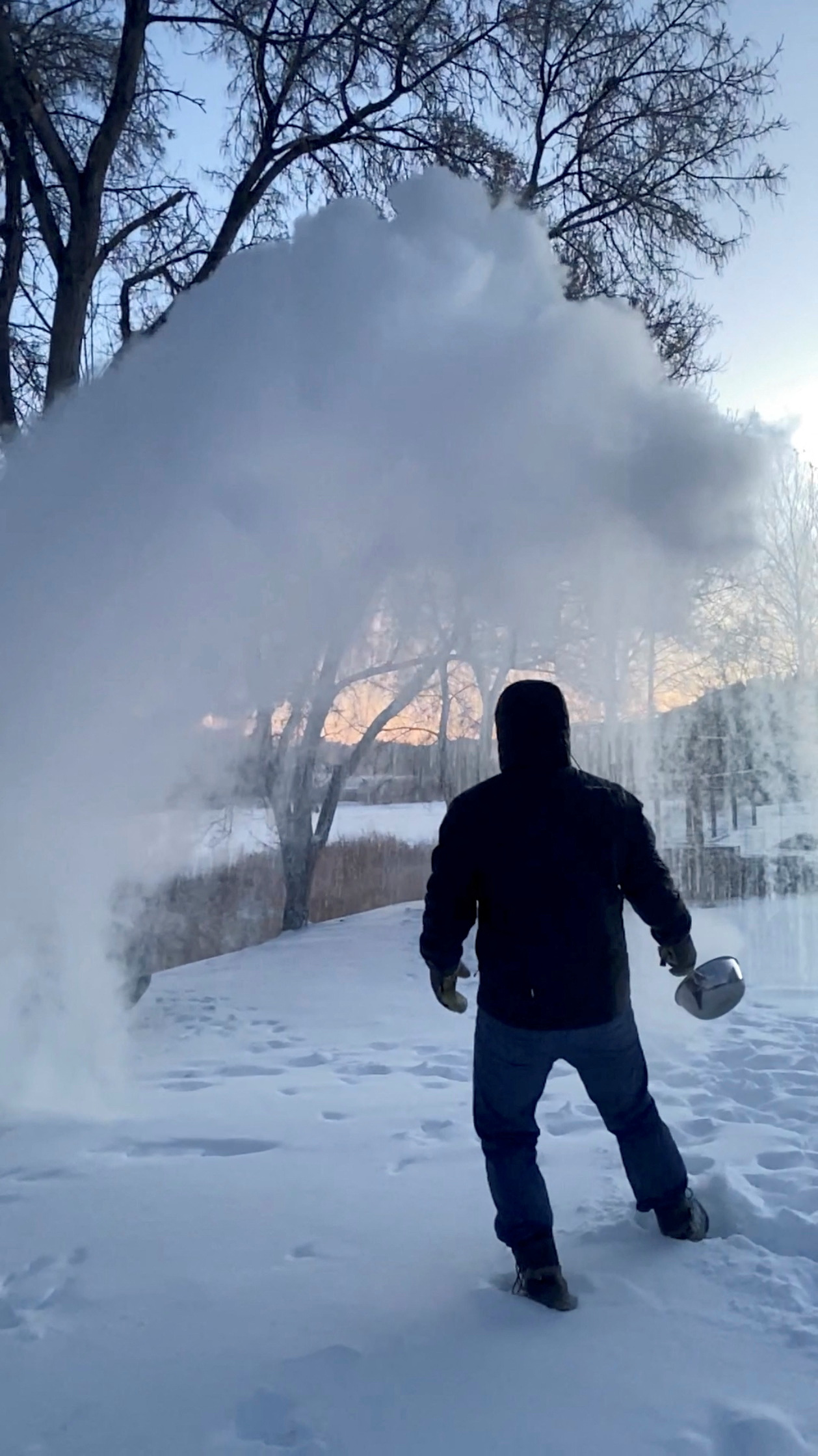 A man tosses hot boiling water in the snow in Carbon County, Montana