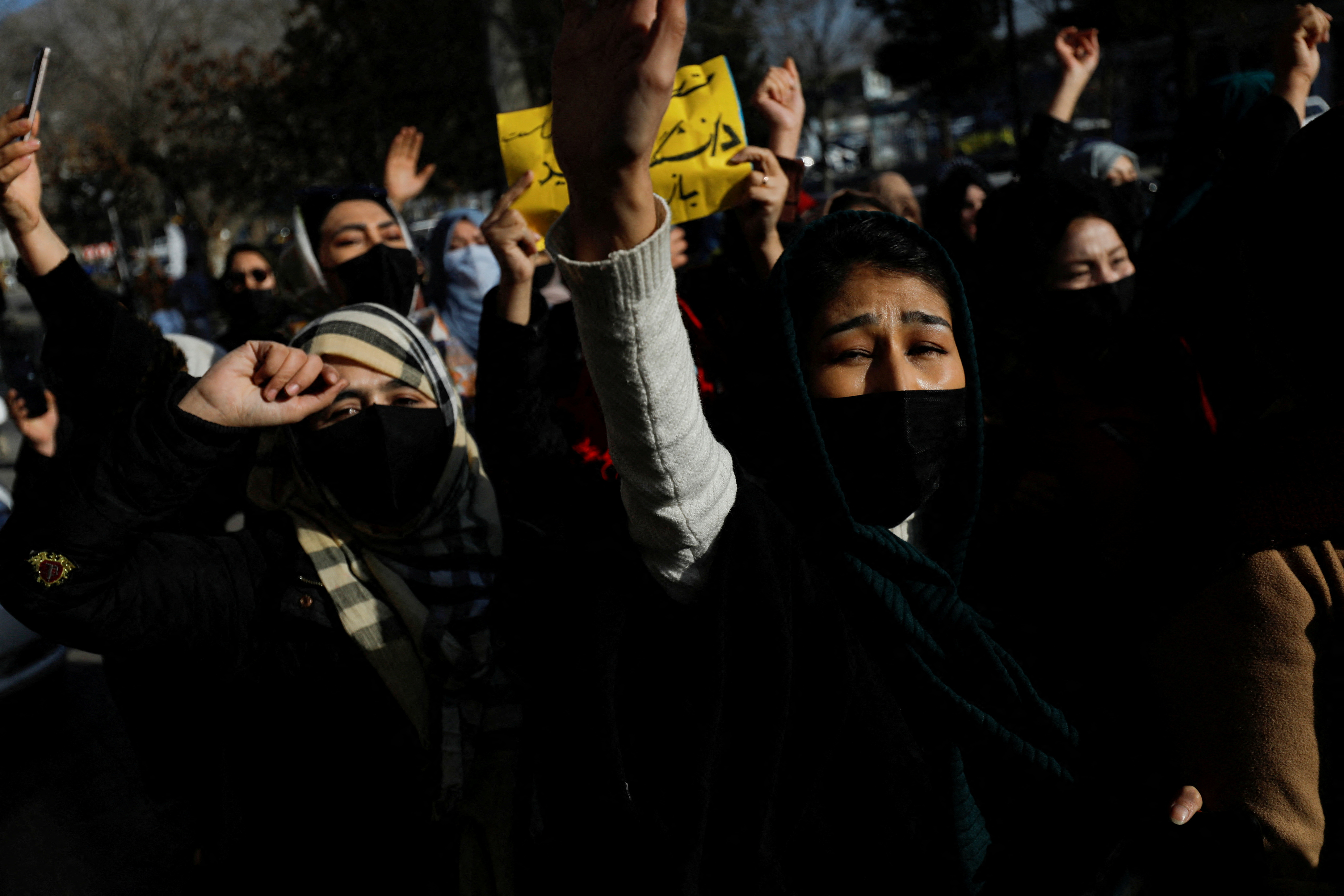 Afghan women chant slogans in protest against the closure of universities to women by the Taliban in Kabul
