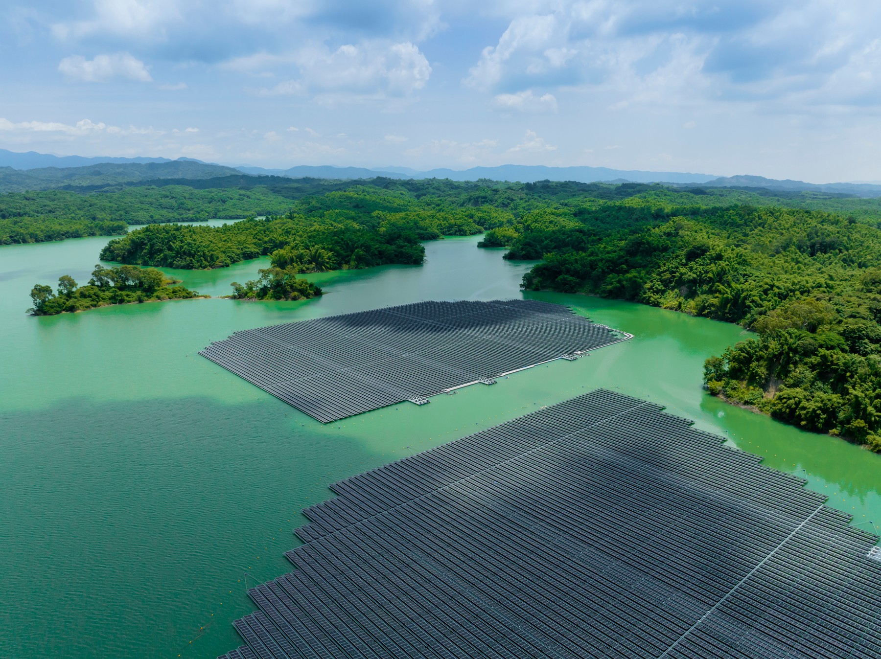 Aerial top view of solar panels or solar cells on buoy floating in lake