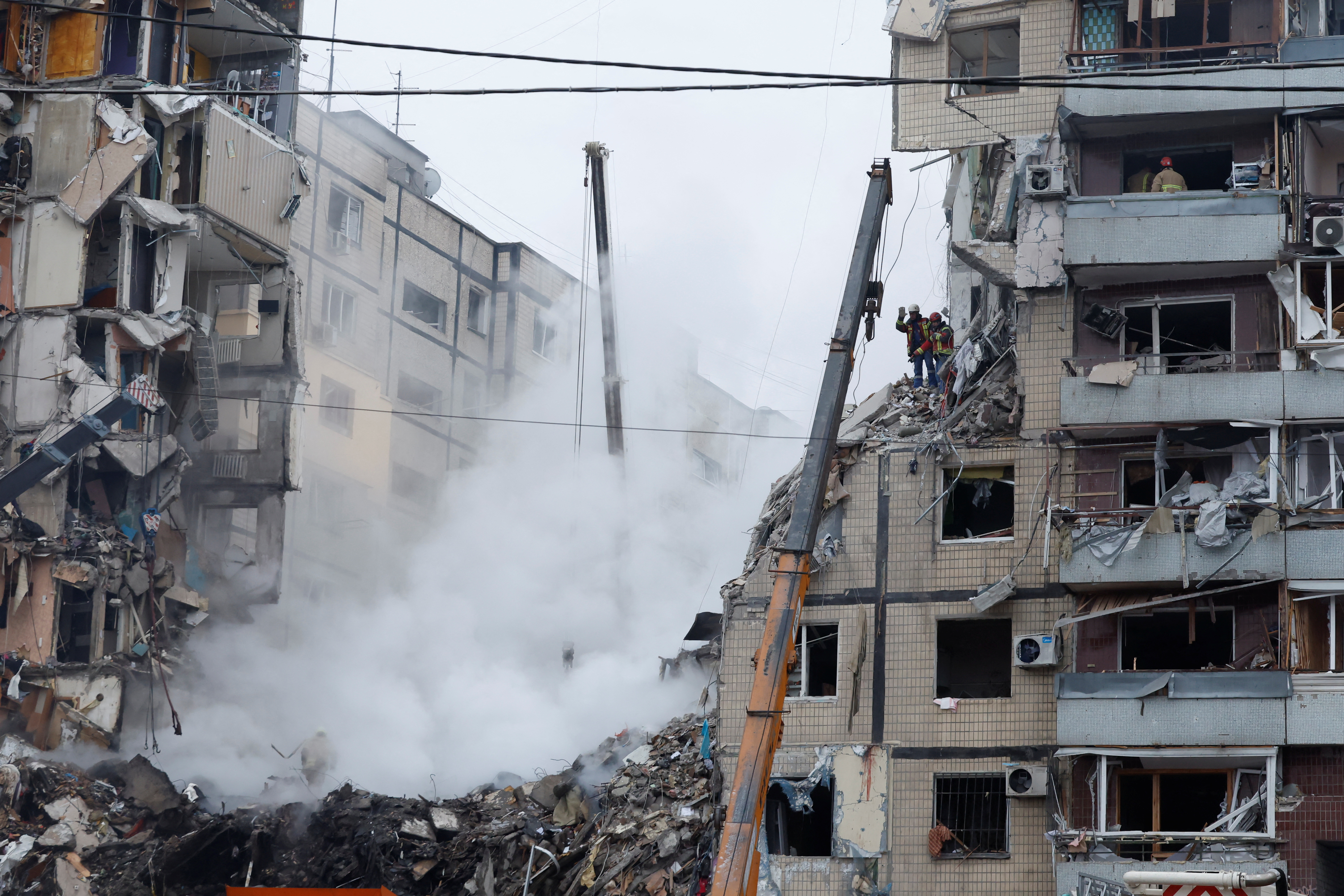 Aftermath of Dnipro apartment block destruction following missile strike