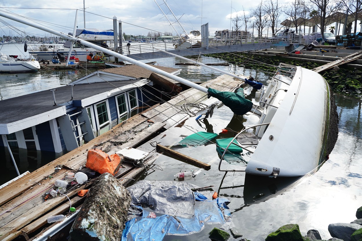 Boat and houseboat submerged in Oakland, California, US - 22 Mar 2023