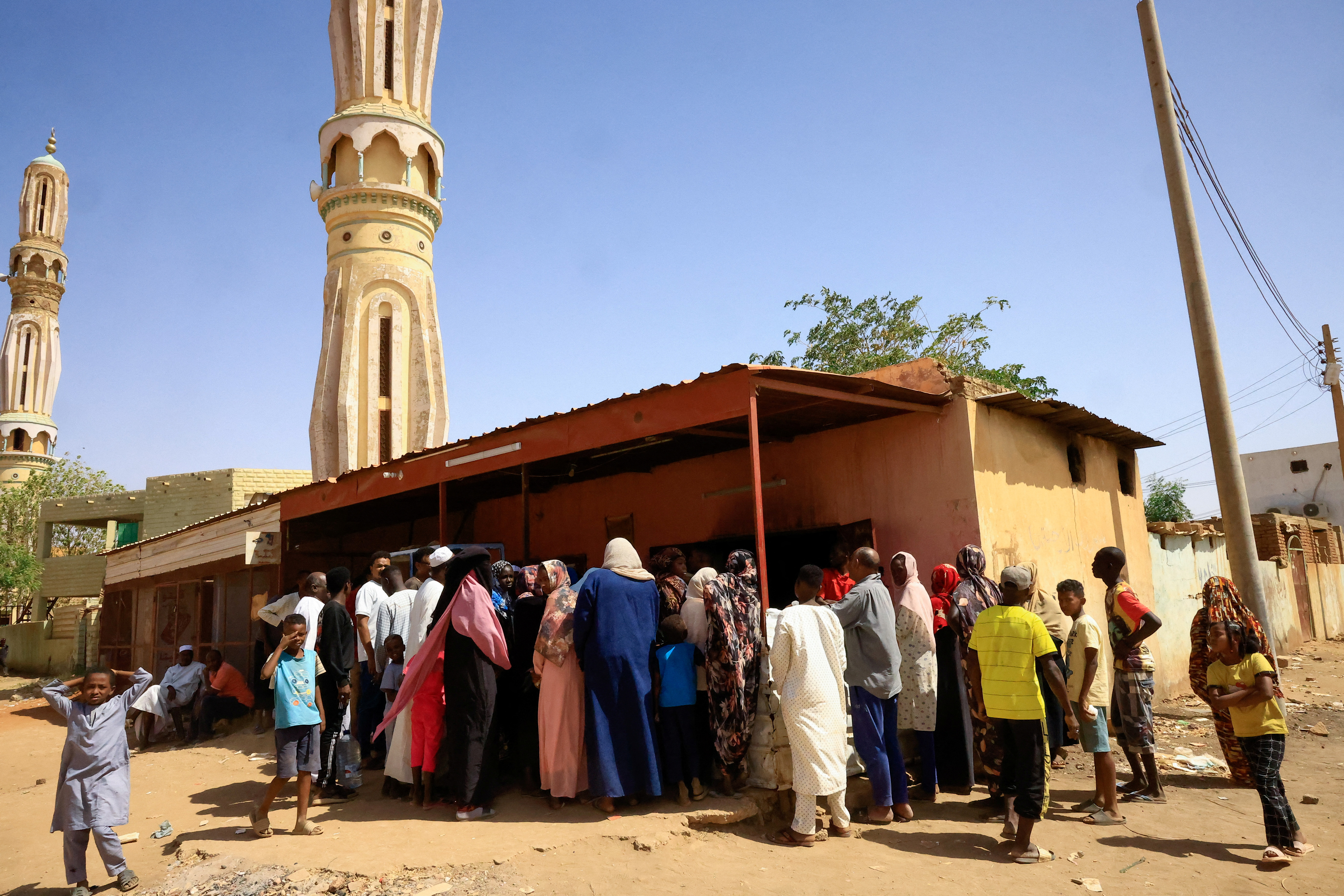 People gather to get bread in Khartoum North