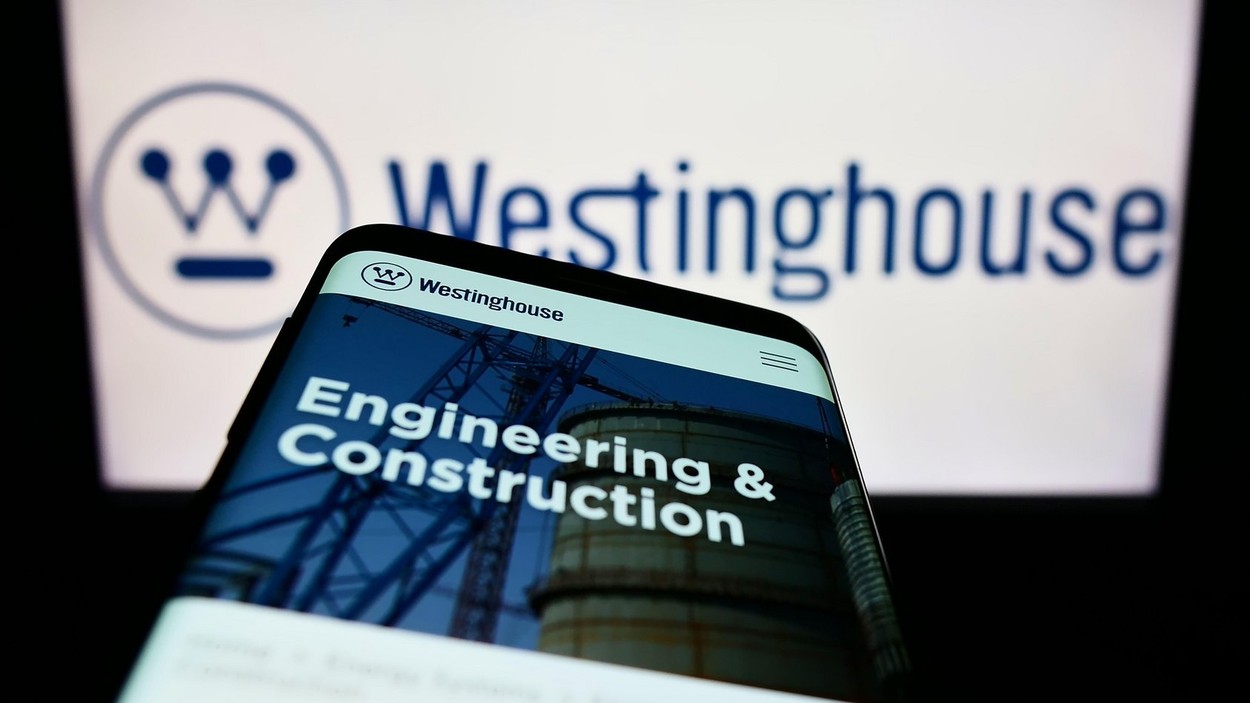 Mobile phone with webpage of Westinghouse Electric Company LLC on screen in front of business logo. Focus on top-left of phone display.
