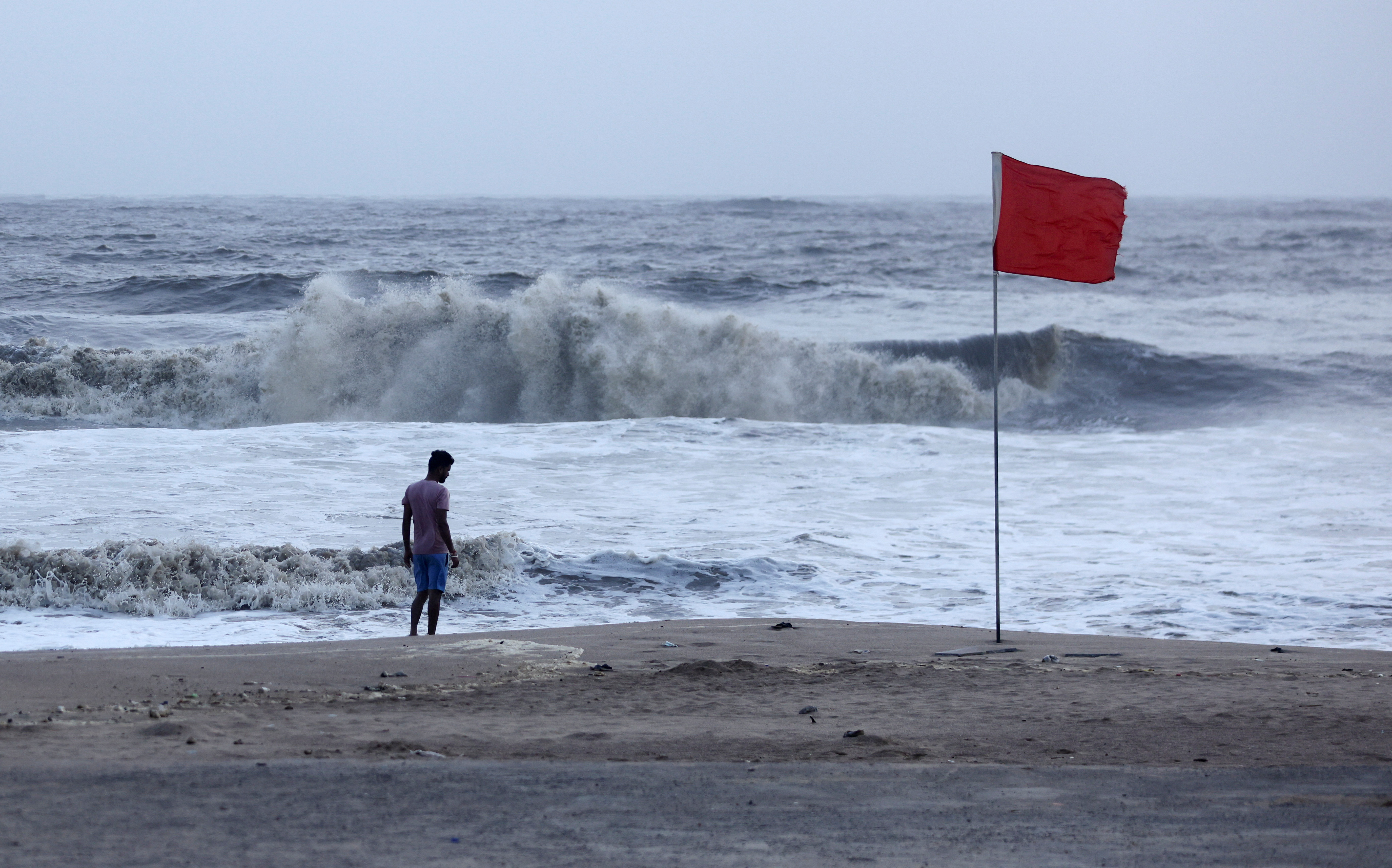 A lifeguard patrols Juhu beach during a red flag alert due to rough seas caused by cyclone Biparjoy, in Mumbai