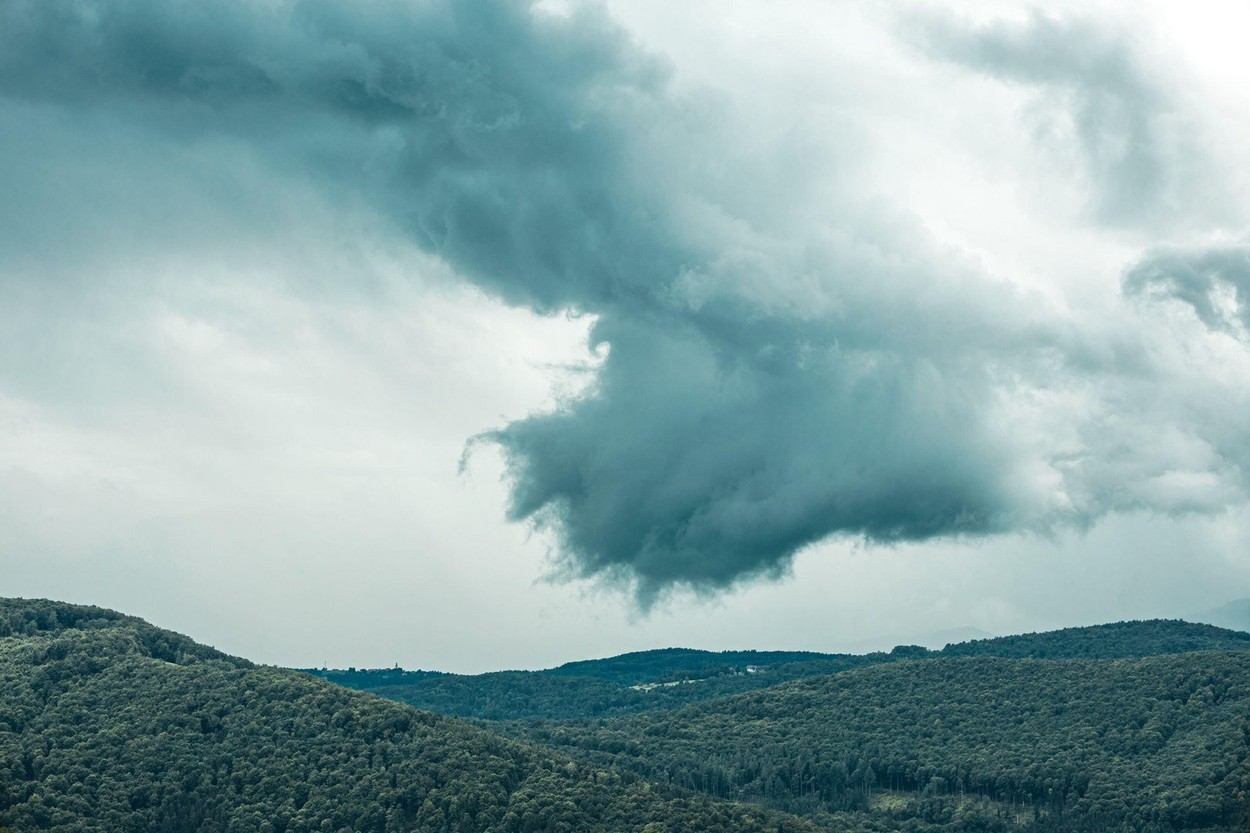 Thick funky storm clouds above slovenia in a round shape with contrast side. Dangerous clouds bringing hail, rain and thunder.