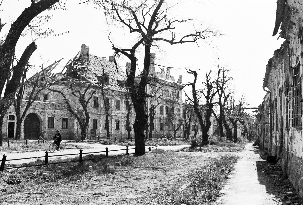 A lone bicyclist rides through the ruins of Vukovar, Croatia, on Thursday, November 7, 1991.