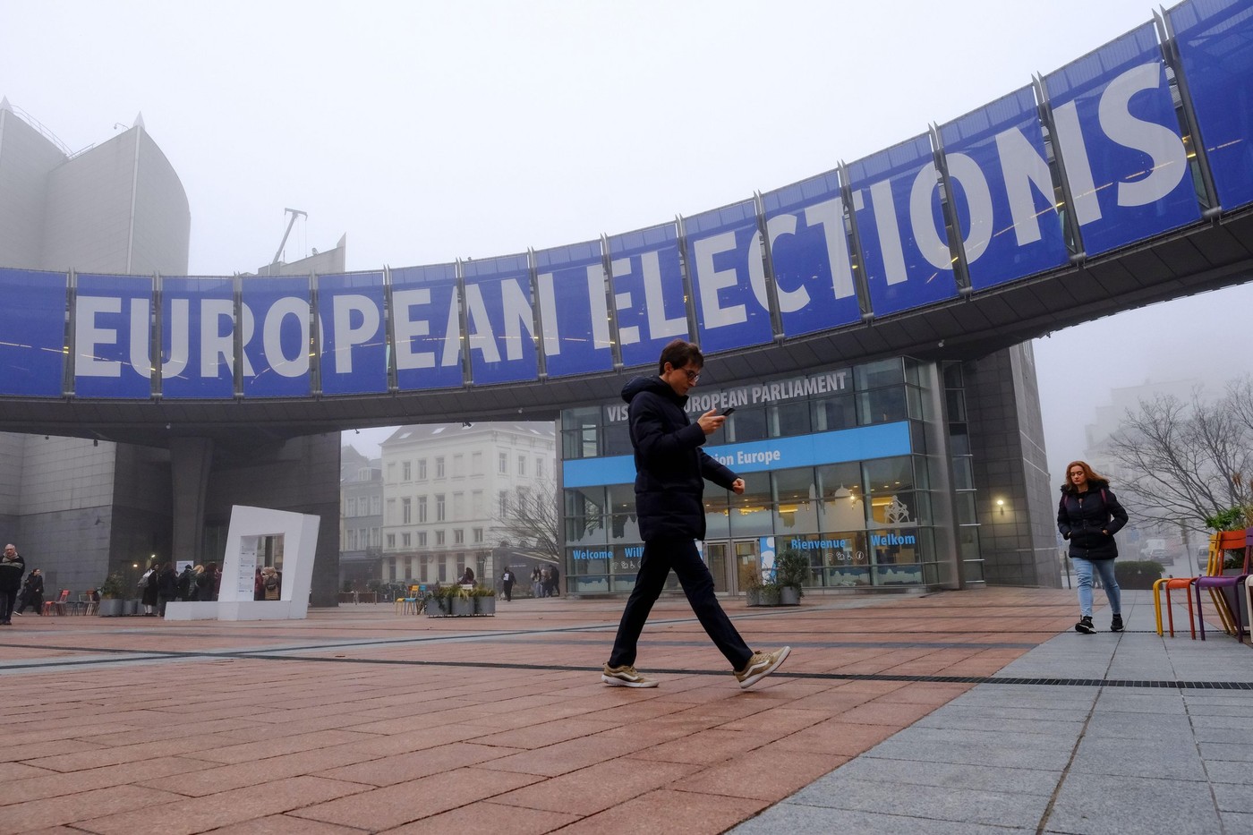 Brussels, Belgium. 25th Jan, 2024. People walk toward a banner advertising the European elections outside the European Parliament in Brussels, Belgium on January 25, 2023. Credit: ALEXANDROS MICHAILIDIS/Alamy Live News