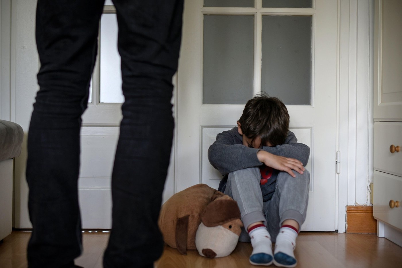 view of a child victim of child abuse in his room