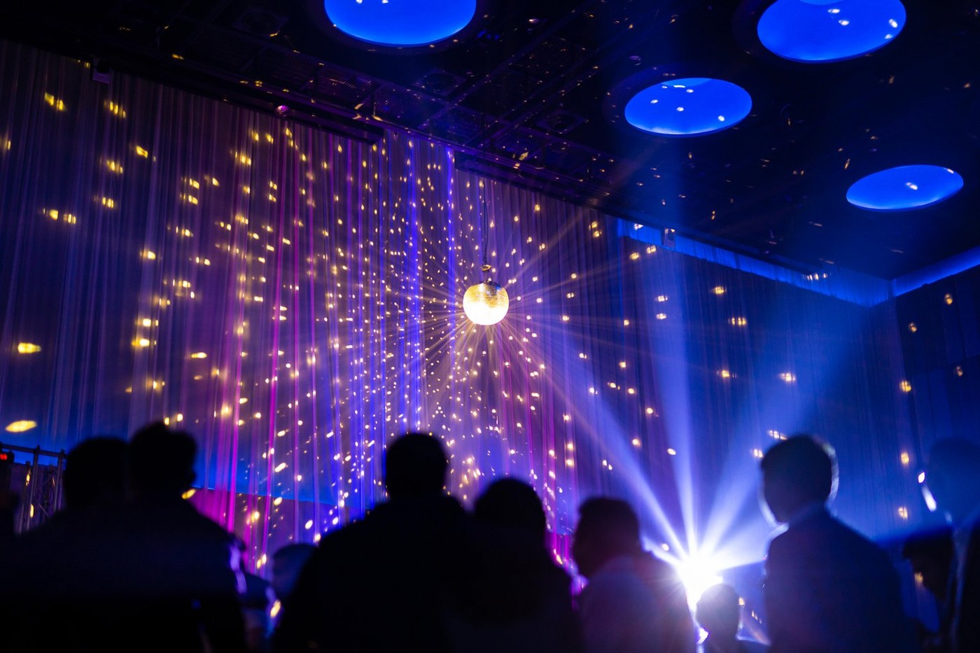 Blurred concept night scene in concert party with audience and lighting.