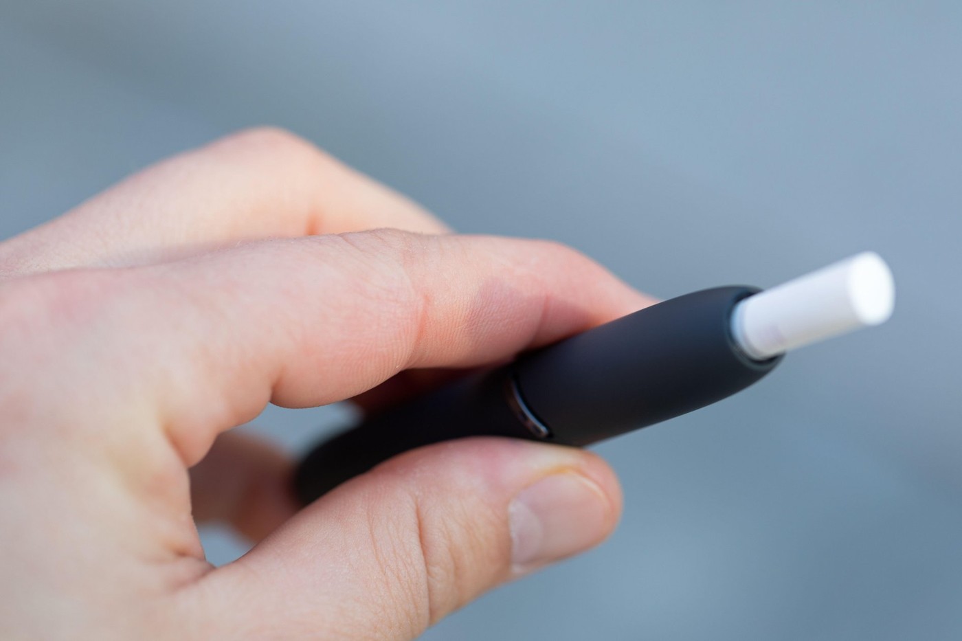 Picture of a man's hand holding an electric cigarette