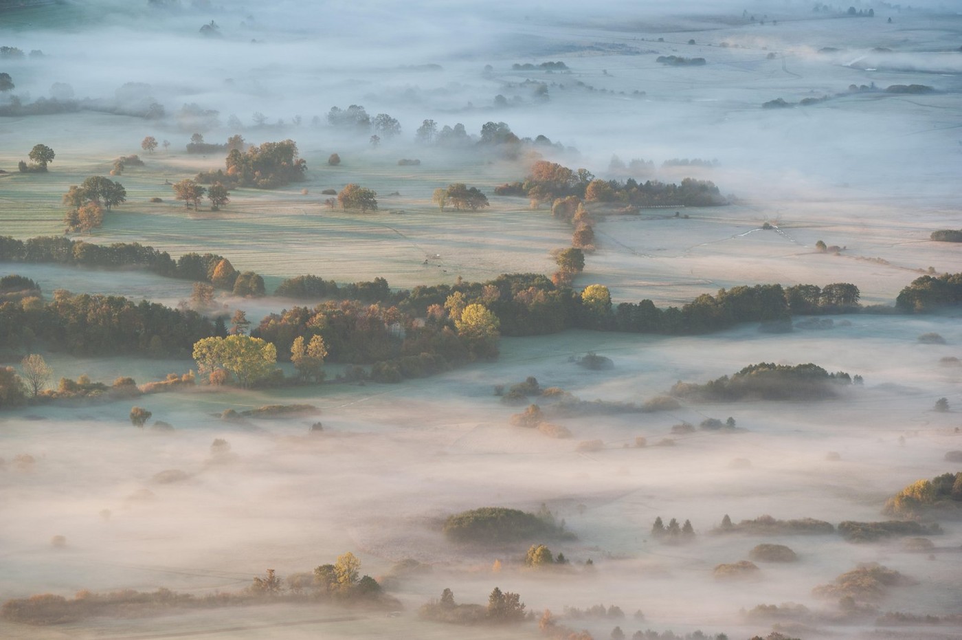 Areal photo of foggy Cerknica lake in dawn.