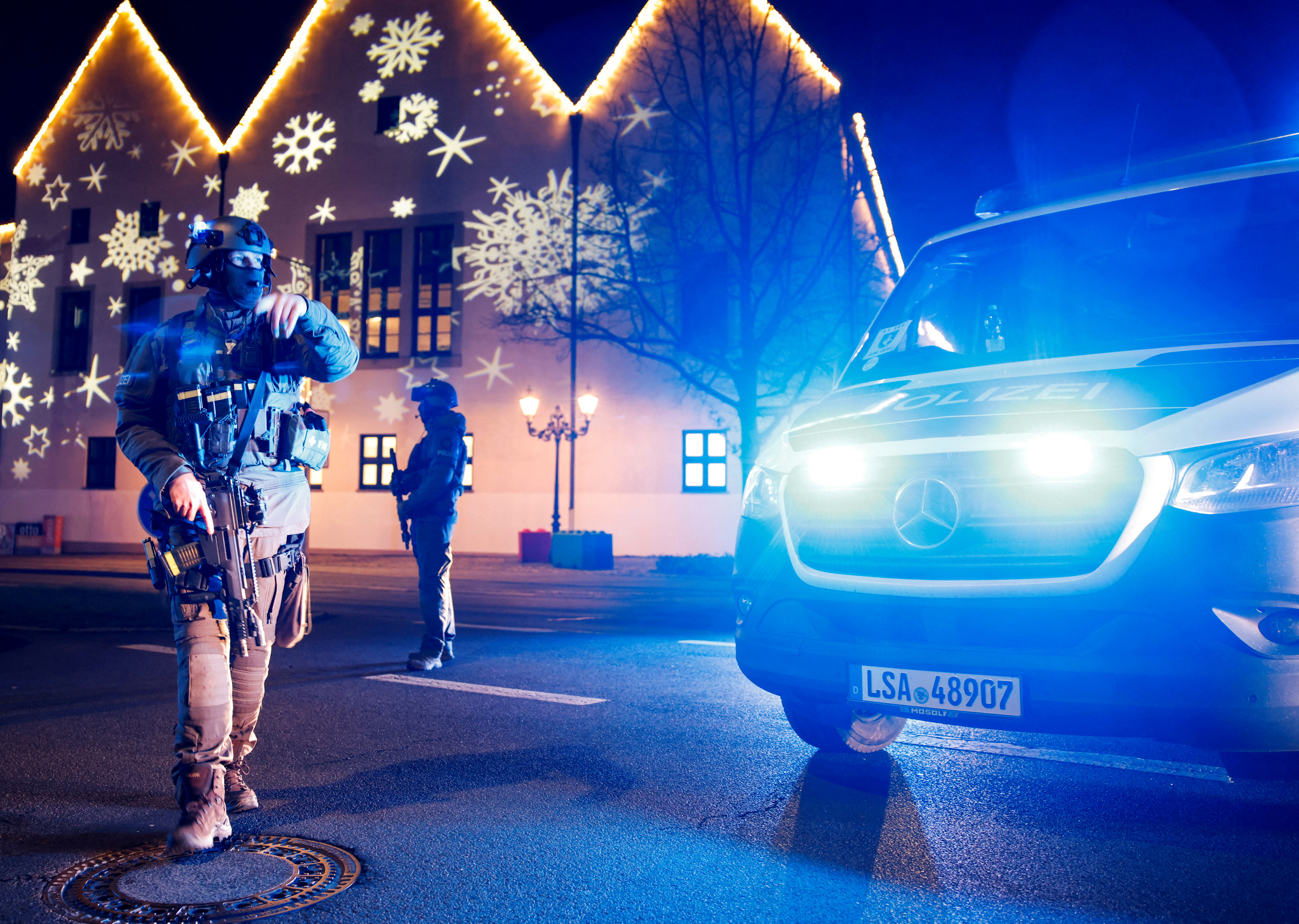 Members of police work at a Christmas market after a car drove into a group of people, in Magdeburg