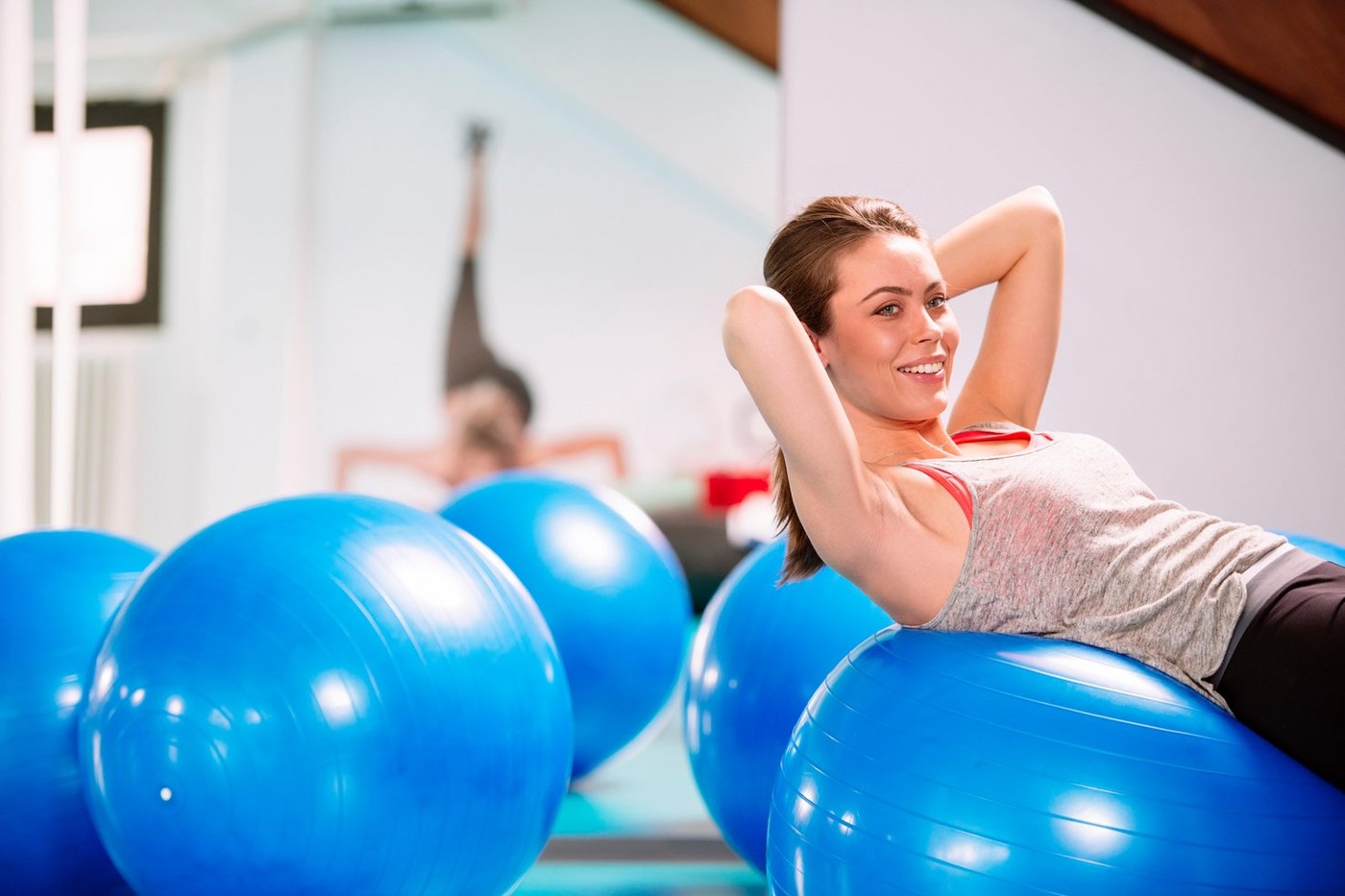 Young woman exercise with pilates balls in the gym