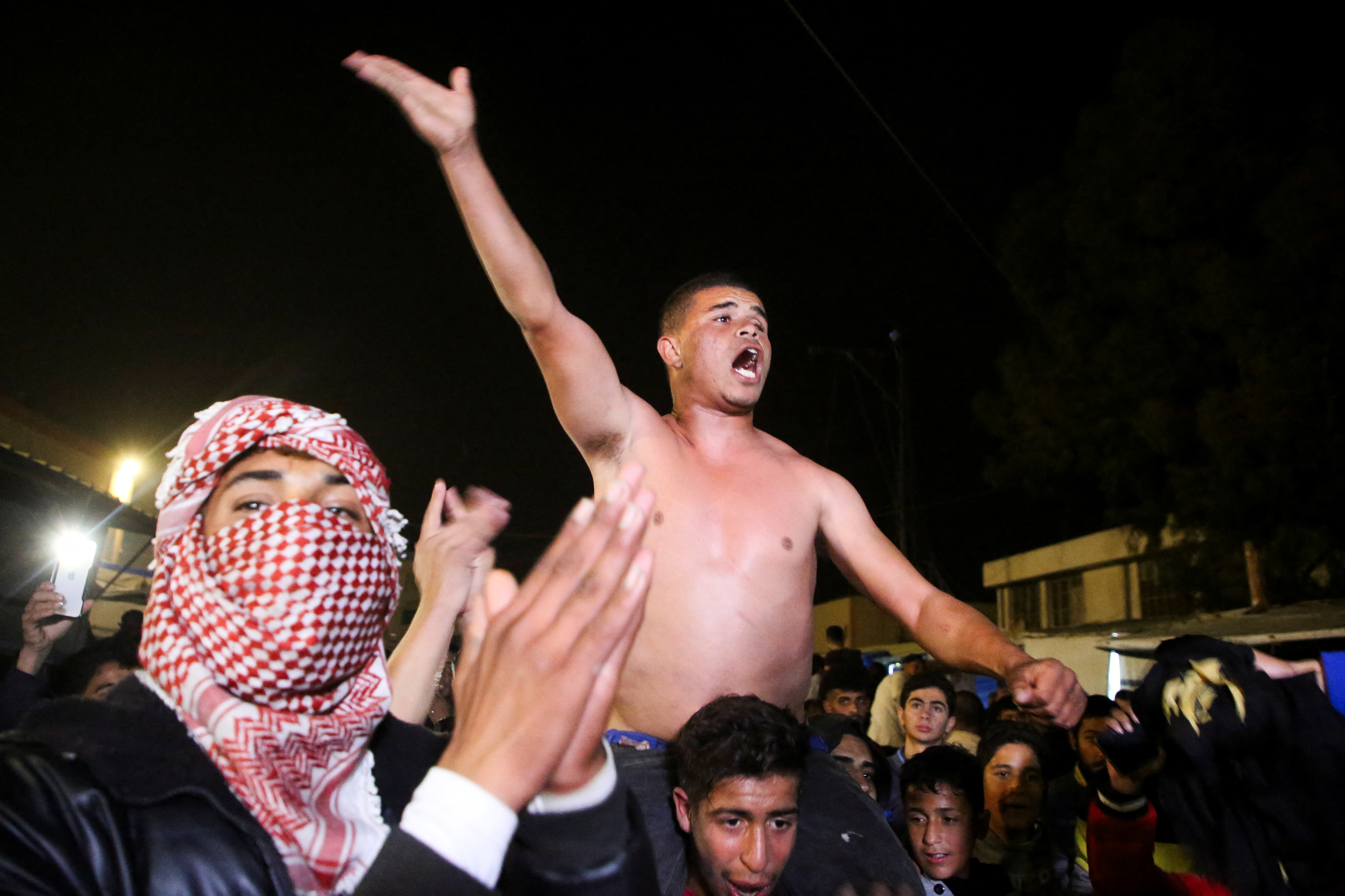 Palestinians react to news on a ceasefire deal with Israel, in Khan Younis in the southern Gaza Strip