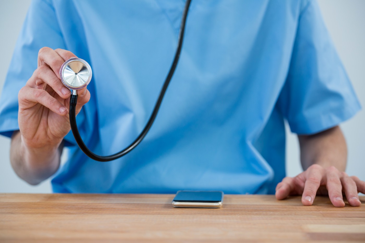 Male nurse holding stethoscope