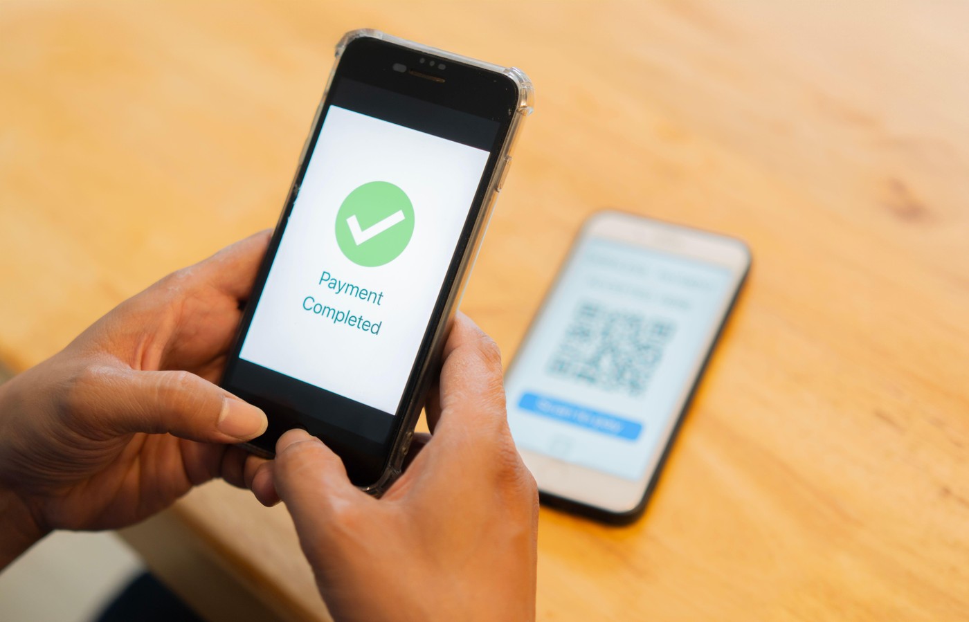 QR code payment concept. Close-up hands using smartphone for digital paying, person paying with mobile phone.