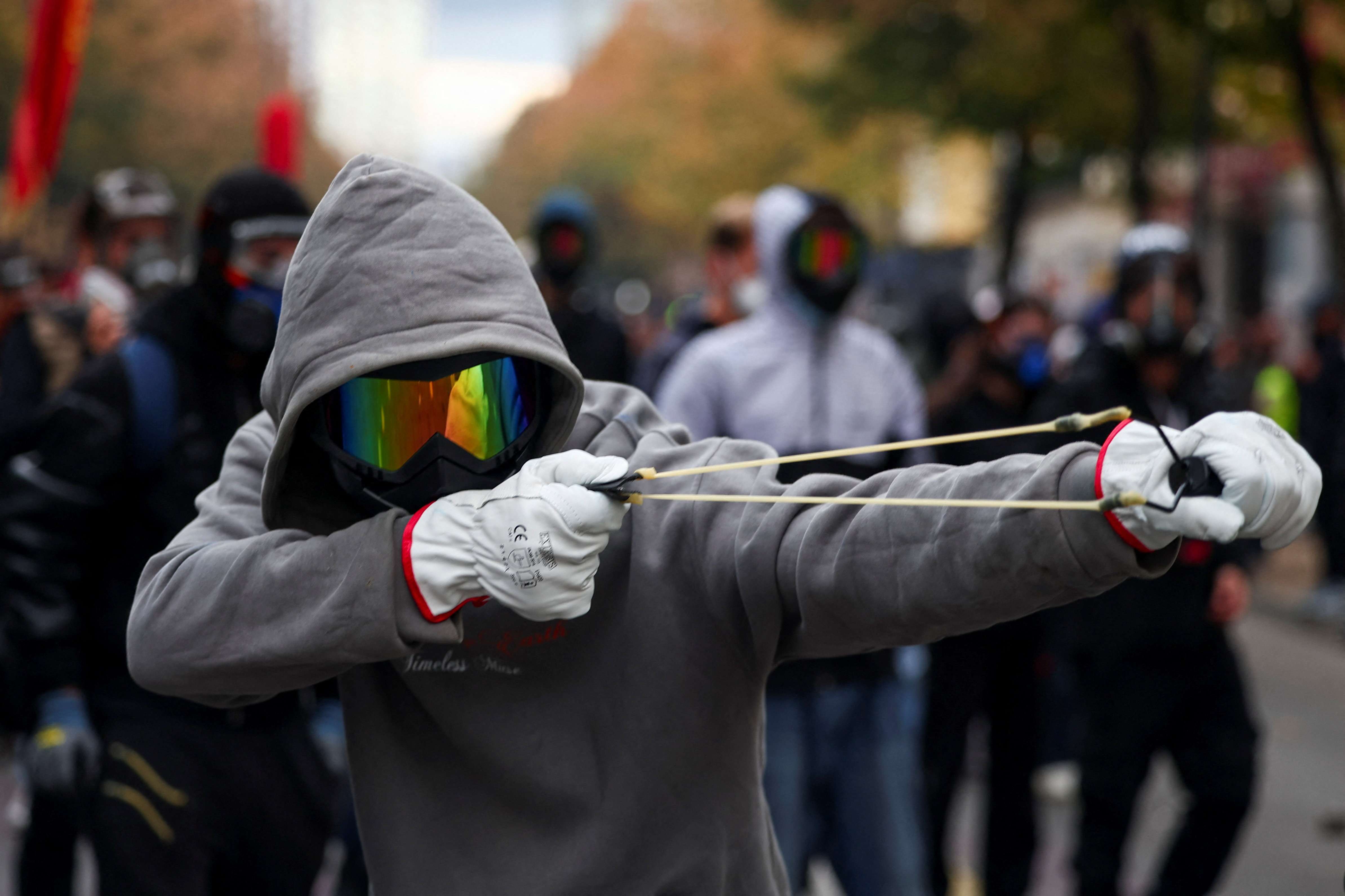 A protester uses a slingshot during an anti-government protest in Tirana, Albania, October 31, 2026. REUTERS/Florion Goga