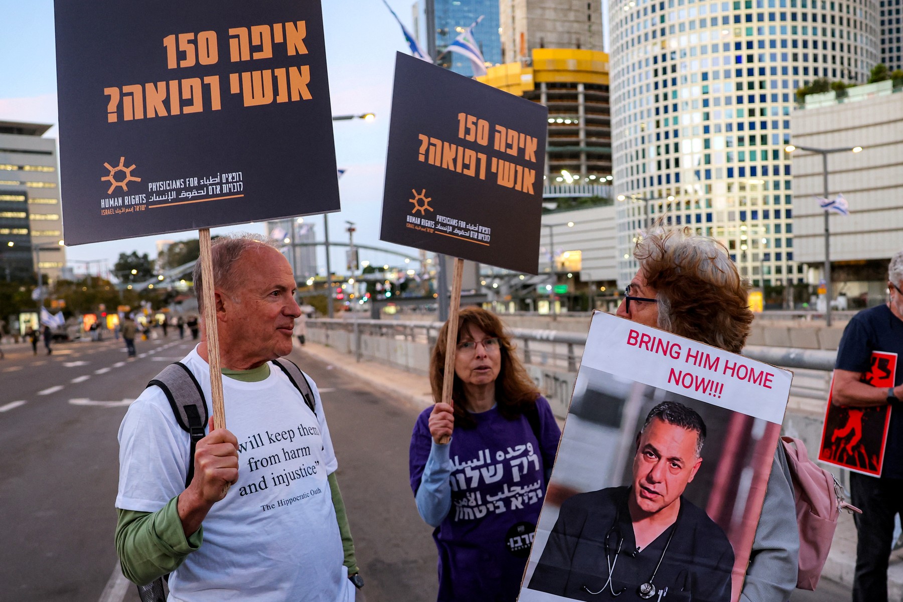 A demonstrator holds a sign depicting Israeli-detained Palestinian paediatrician Hussam Abu Safiya Tel Aviv on April 5, 2025.