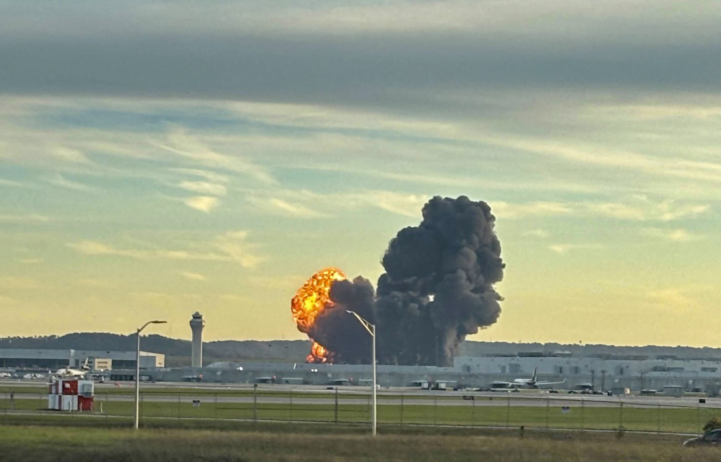 This handout photo courtesy of Levi Dean shows smoke and flames rising from the site of a UPS cargo plane crash outside Louisville International Airport in Louisville, Kentucky, on November 4, 2025