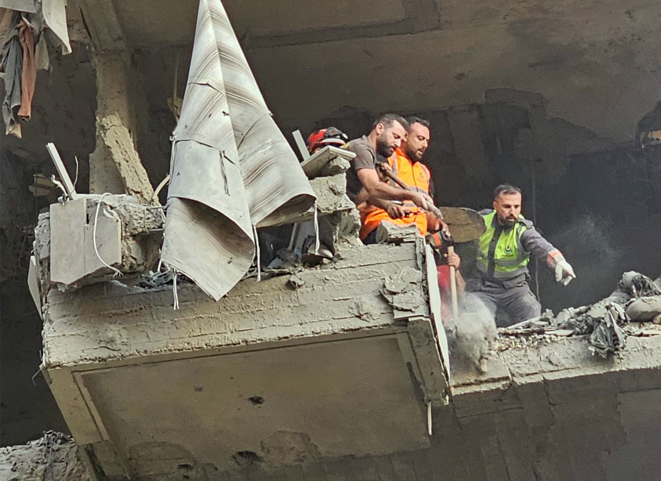 Rescuers search for survivors at the site of an Israeli air attack that targeted a residential building in Beirut’s southern suburbs Haret Hreik