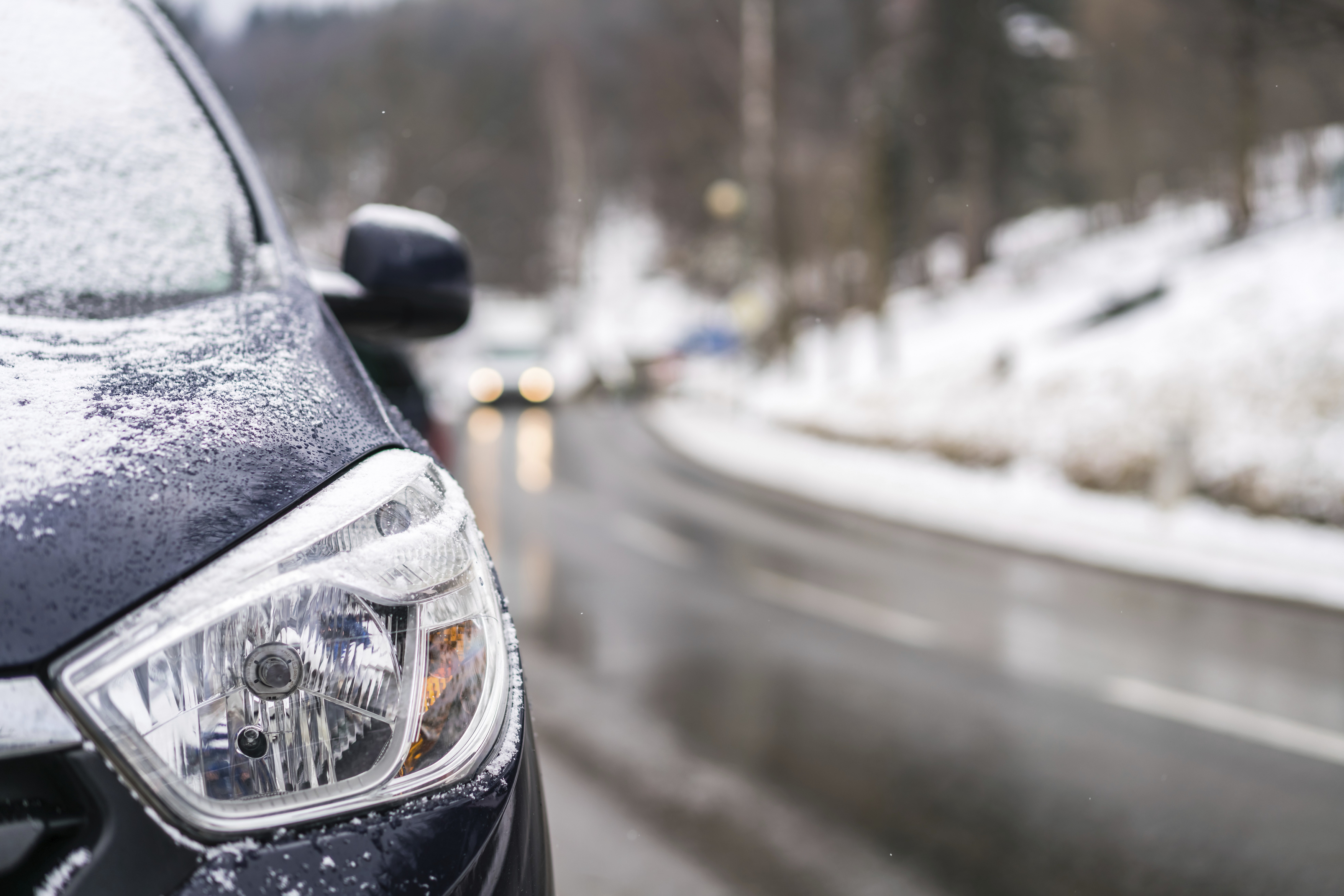 Close up of a light of a car parked on the roadside of the road in polish ski resort of Karpacz after heavy snowfall,Image: 1051324983, License: Royalty-free, Restrictions: , Model Release: no