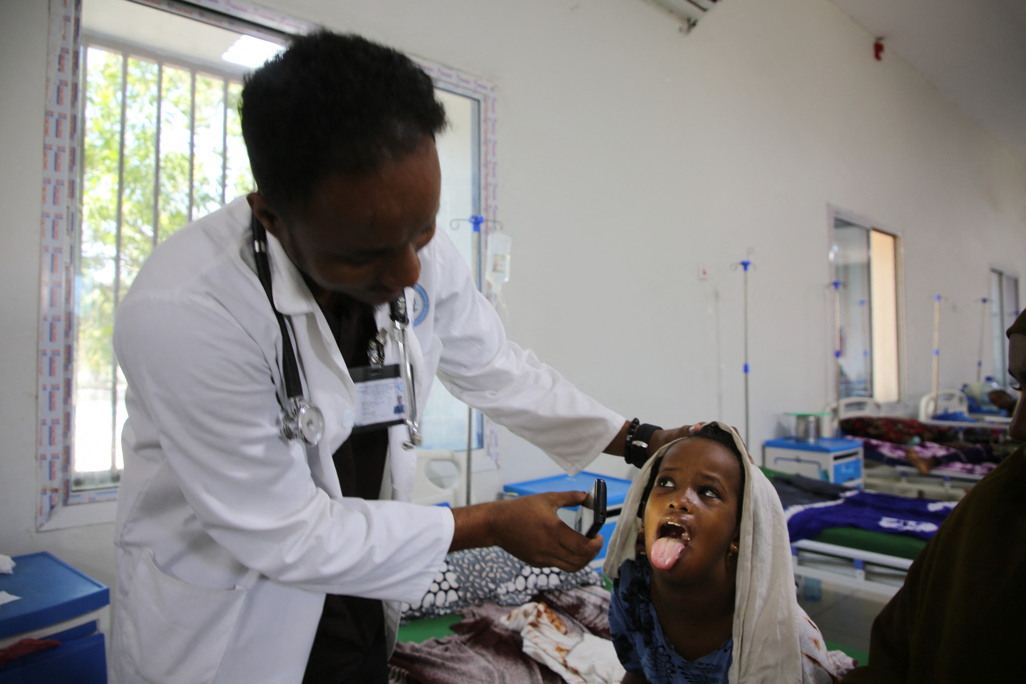 MOGADISHU, SOMALIA - DECEMBER 16: A doctor treats a child at a hospital in the Somalian capital Mogadishu on December 16, 2025.