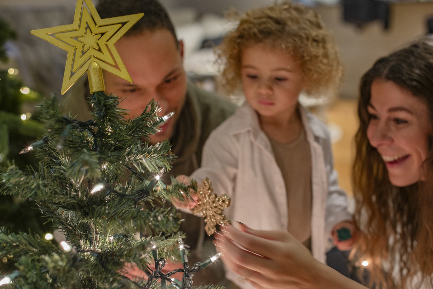 družina krasi božično drevesce