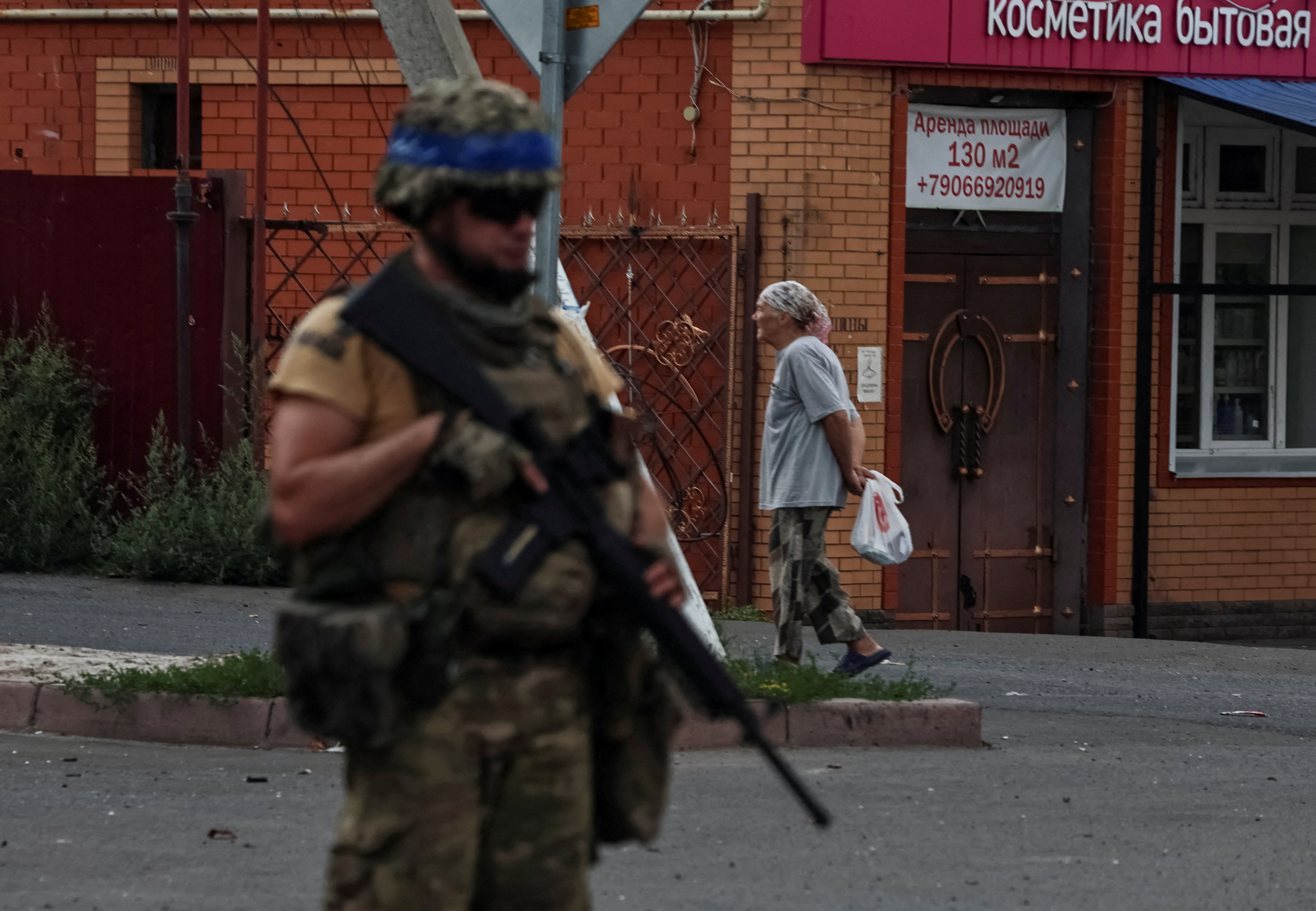FILE PHOTO: A Ukrainian serviceman patrols in the town of Sudzha
