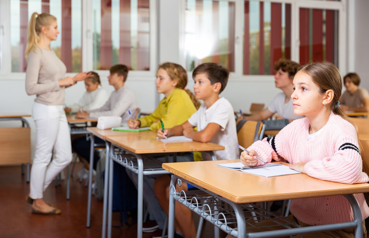 Young boys and girls studying in classroom