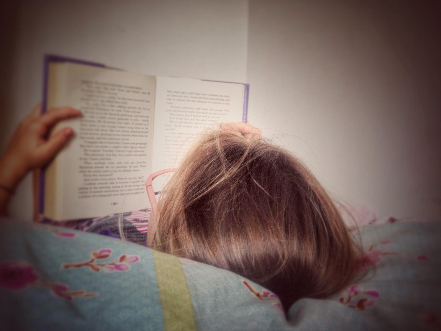 Child reading in bed.