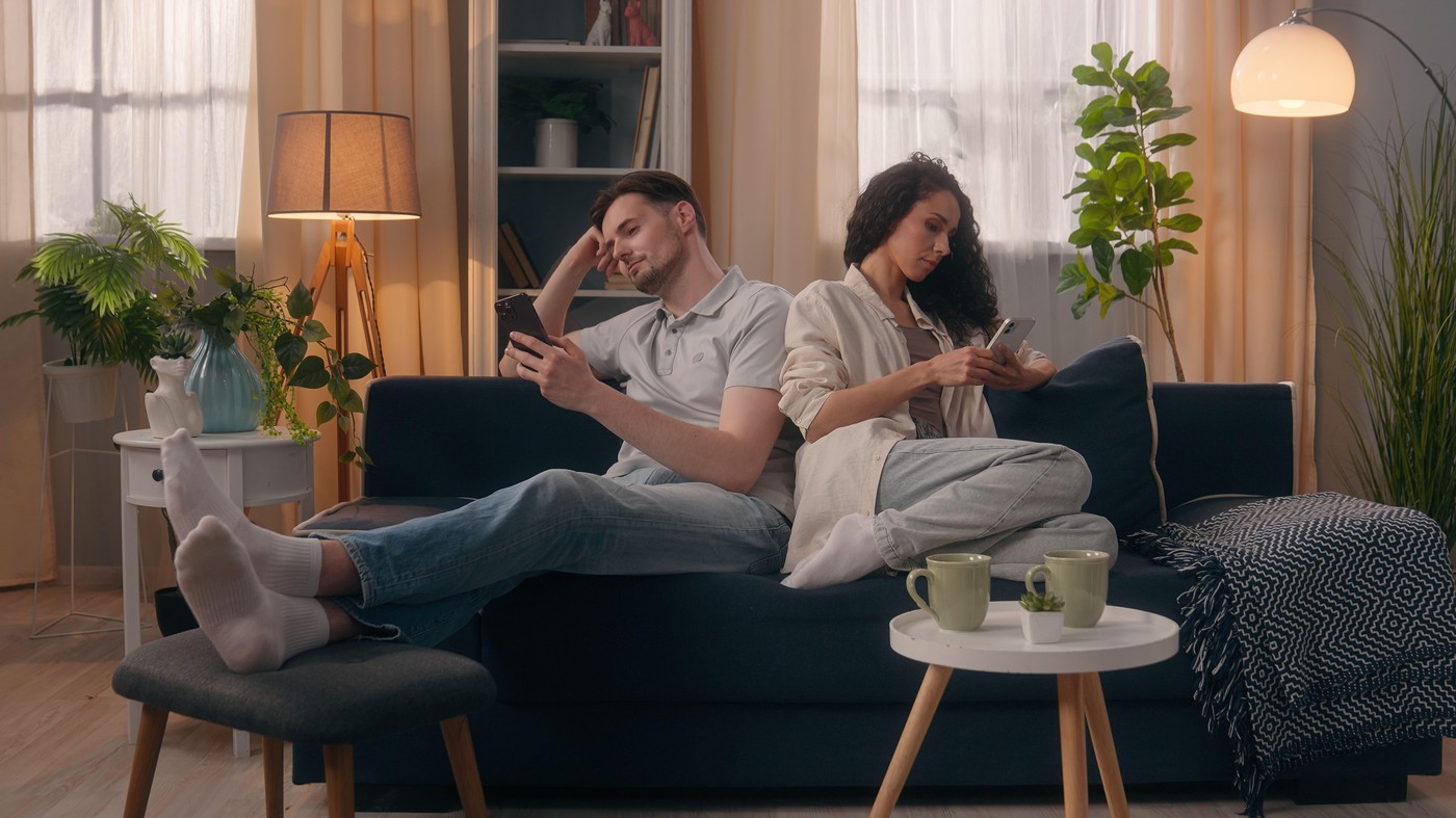 Gadget addicted family internet social media dependence addiction couple separated ignoring Caucasian man guy male husband boyfriend Hispanic woman