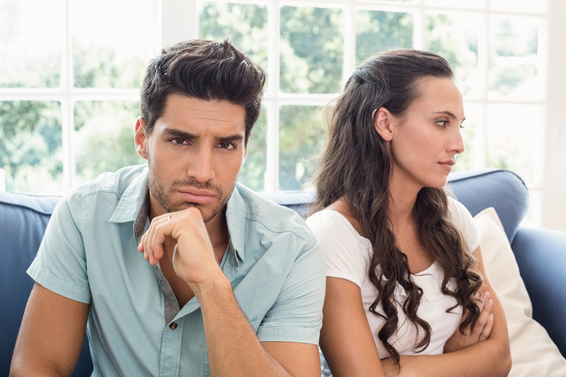 Attractive couple not talking on the couch at home in living room,Image: 196207550, License: Royalty-free, Restrictions: , Model Release: yes